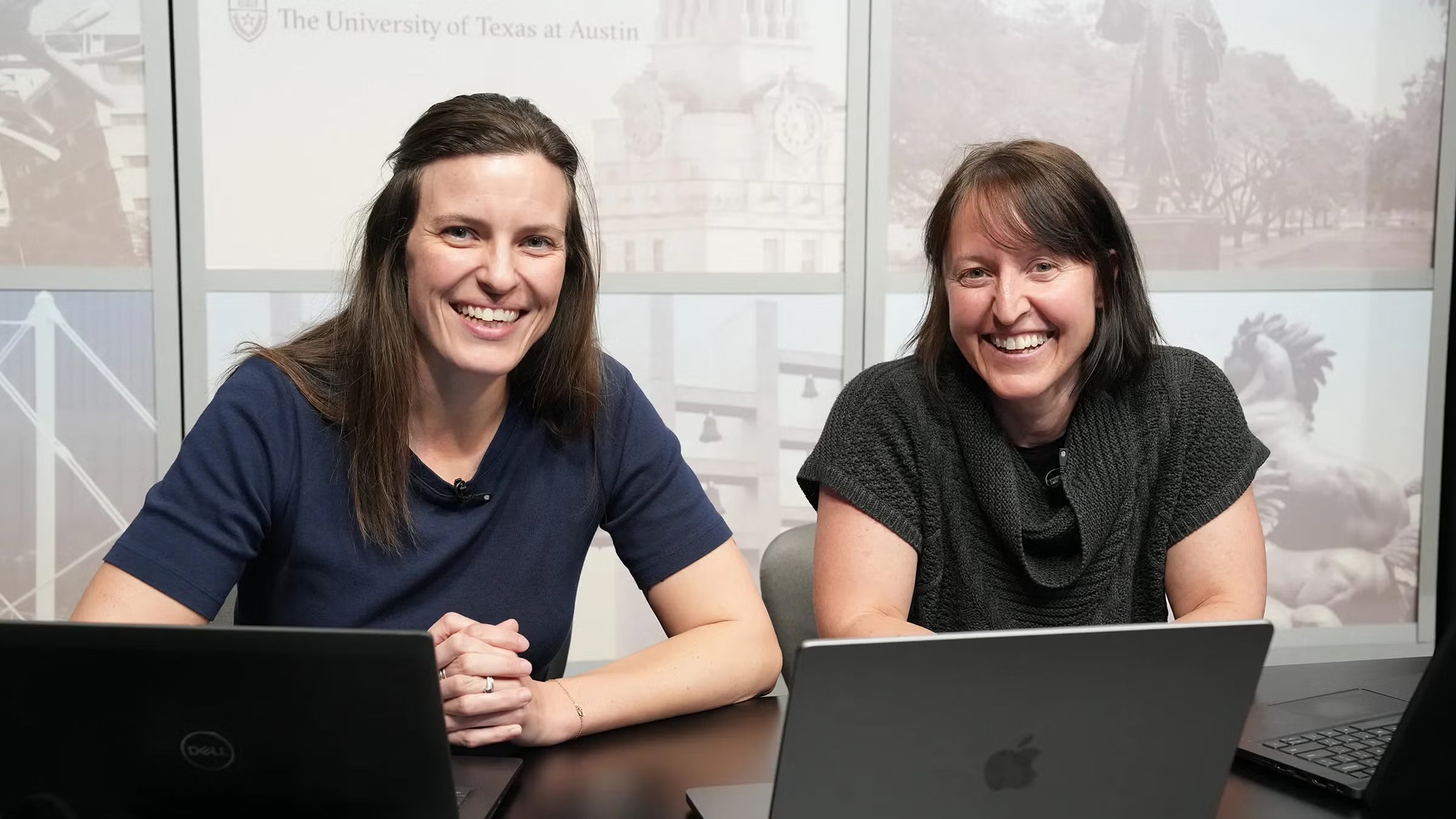 Michele Hockett Cooper and Heather Leidy sitting at a desk